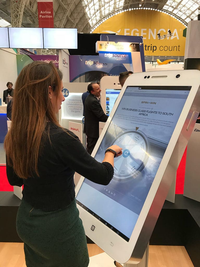Attendee interacts with the Star Allianz Digital Spin Wheel at Travel Trade Show