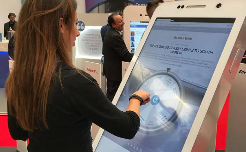 a woman playing spin to win on a big interactive screen