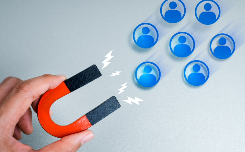 Lead generation concept: a magnet attracting blue user icons, symbolizing customer acquisition.